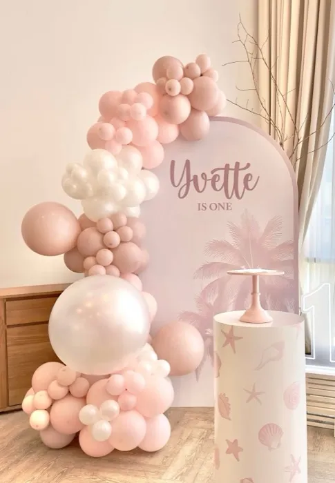 Custom pastel balloon-arch backdrop example with personalised name signage